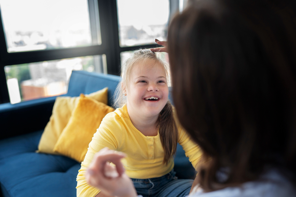 high angle smiling girl with down syndrome at private nursery in Glasgow